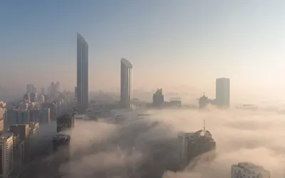 Fog drapes UAE skylines in soft winter-white hues