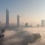 Fog drapes UAE skylines in soft winter-white hues