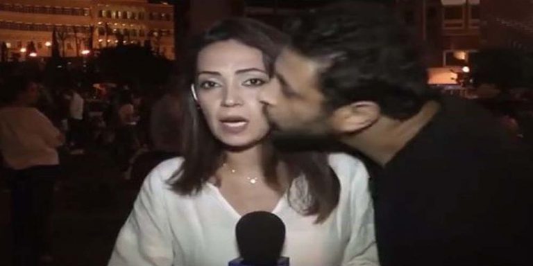 Lebanese protester kisses reporter live on air