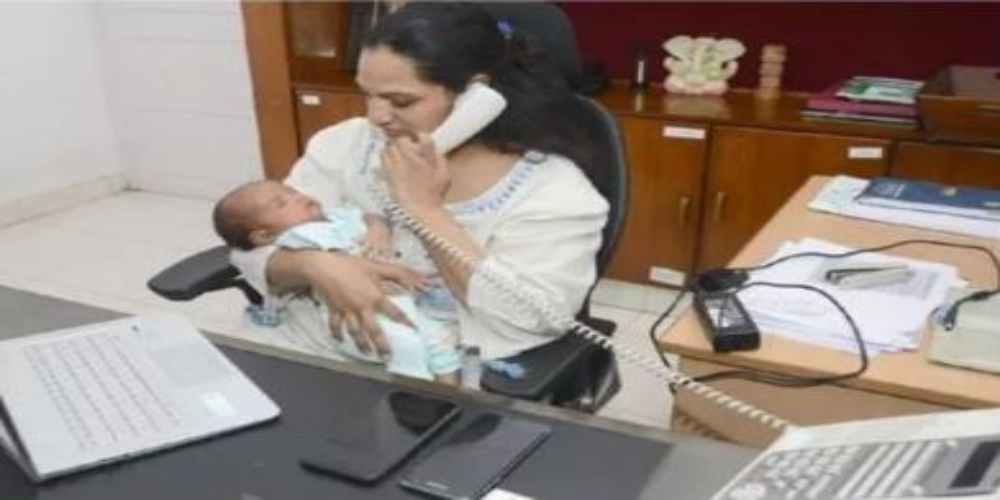 IAS officer returns to work in a week after her delivery, holding her newborn while working