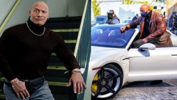 Dwayne Johnson gets stuck in a Porsche during a shoot