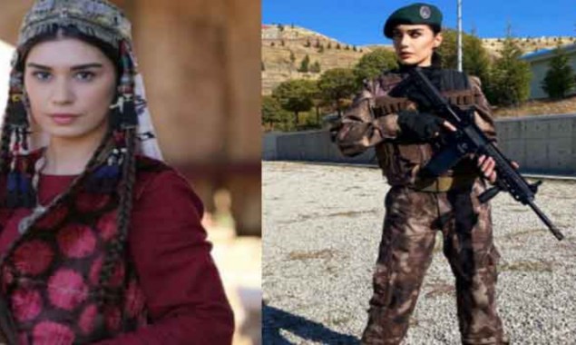 Burcu Kiratli poses with assault rifle donned in a military attire