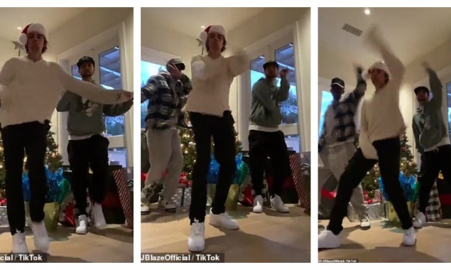 Justin Bieber dances with friends by the Christmas tree