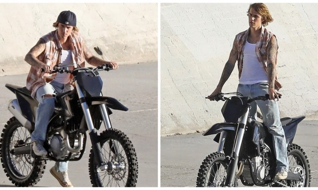 Justin Bieber models riding a dirt bike on the banks of Los Angeles River