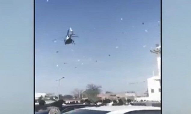 Money showered from helicopter at a wedding