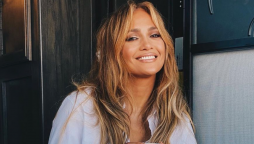 Jennifer Lopez shows a cheerful smile with coffee talk