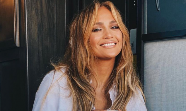 Jennifer Lopez shows a cheerful smile with coffee talk