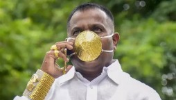 Indian man wearing gold face mask