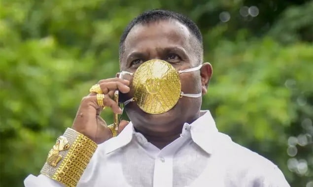 Indian man wearing gold face mask