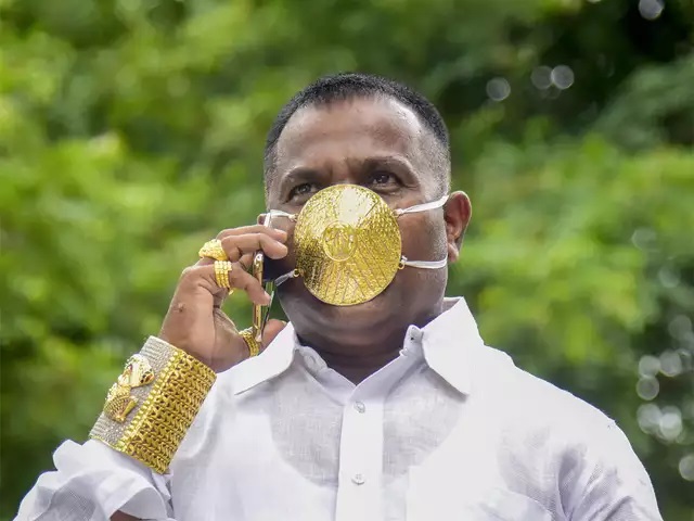 Indian man wearing gold face mask