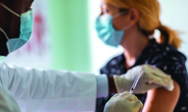 Half of total US population fully vaccinated