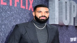 Drake proves his status as a millionaire by showing off his cash 