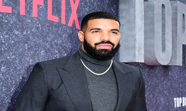 Drake proves his status as a millionaire by showing off his cash 