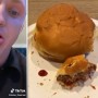 Young man gets stung by bee while eating hamburger
