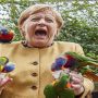 Angela Markel pecked by a dozen of parrots in bird park