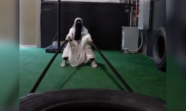 Video: Woman wearing abaya and niqab exercising on loaded machines