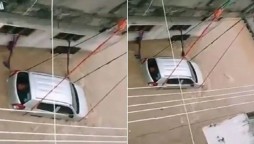 Watch: Car tied to keep from washing away in floodwater