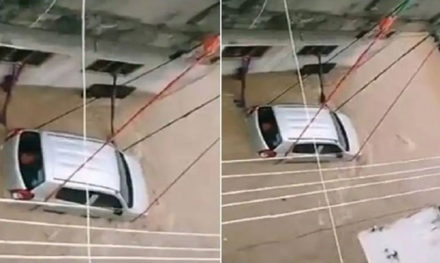 Watch: Car tied to keep from washing away in floodwater