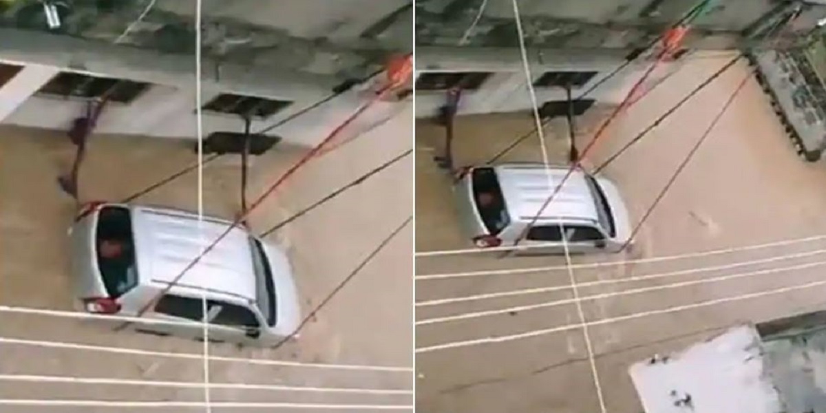 Footage of a car tied with rope to keep it from being in floodwater