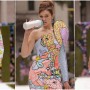 Gigi Hadid hits the Moschino runway in two different looks while feeding on a bottle