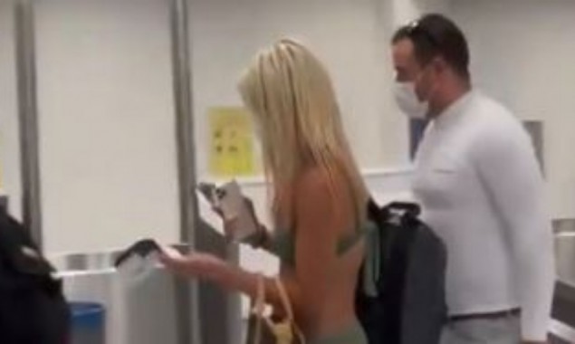 Woman passenger walks through airport in just bikini and face mask---Video goes viral