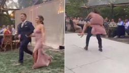 bride and groom fall off the stage while dancing