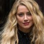 Amber Heard shows off her multi-tasking skills as a new mother