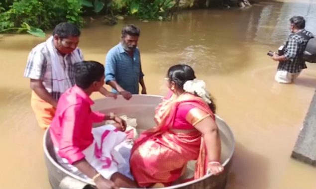 Watch: Severe flooding forces couple to float to their wedding in a cooking pot