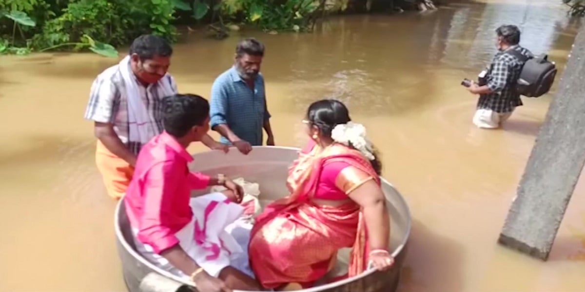 Watch: Severe flooding forces couple to float to their wedding in a cooking pot