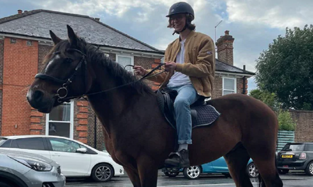 Midst of the UK's fuel crisis: A man rides his horse to a petrol station