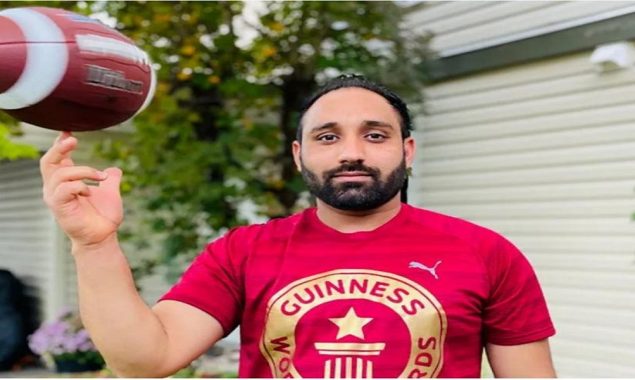 World record: A man spins a football for 21.66 seconds on his finger