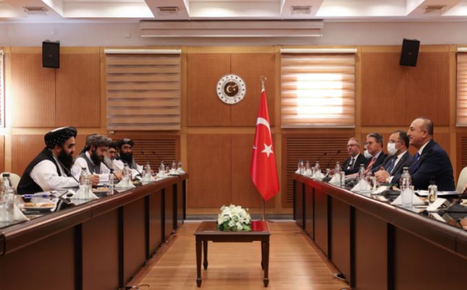 Turkish Foreign Minister Mevlut Cavusoglu (1st R) meets with Afghanistan's acting Foreign Minister Amir Khan Muttaqi