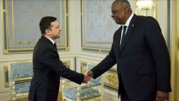 Ukrainian President Volodymyr Zelensky and US Defense Secretary Lloyd Austin shake hands during a meeting in Kiev on October 19, 2021.