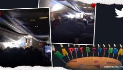 Passengers and airline crew sing "Happy Birthday" to twin girls on board