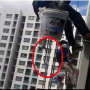 Woman cuts the support rope of two workers left dangling from 26th floor