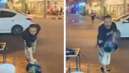 Street vendor tosses food from a wok to a man in viral video