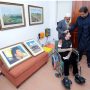 Artist suffering from cerebral palsy gifts PM Imran portraits