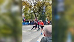 Two runners help the man who falls 200m from NYC Marathon finish line