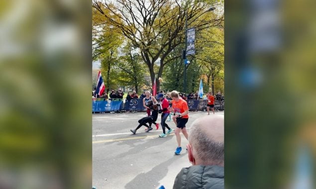 Two runners help the man who falls 200m from NYC Marathon finish line