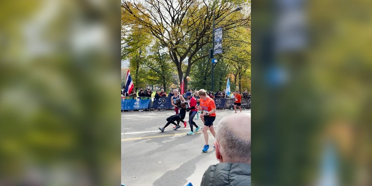 Two runners help the man who falls 200m from NYC Marathon finish line