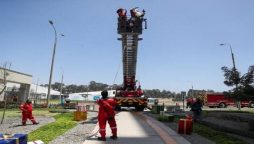 Santa Claus deliver gifts in hospital on a firefighters’ ladder