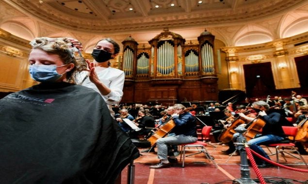 Customers get a haircut in a hall as museums and concert halls protest against the Dutch government