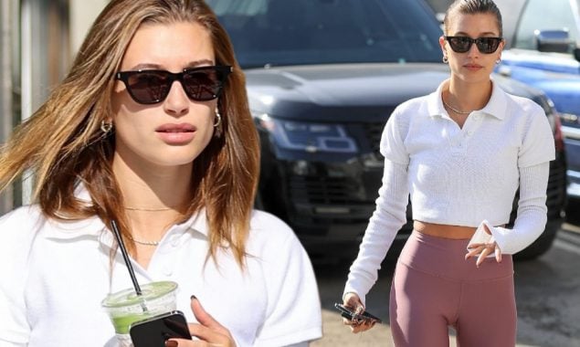 Hailey Bieber flaunts her toned body in a cropped top and leggings