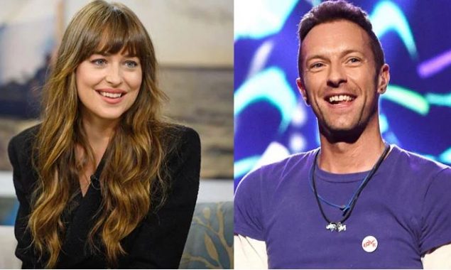 Chris Martin fixes the camera for Dakota Johnson