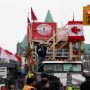 Canada truckers defy order to clear key bridge as protests swell