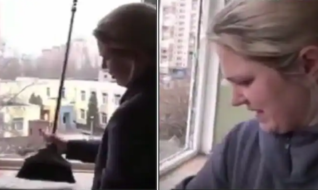 Ukrainian woman tearfully sings the national anthem while cleaning the glass of her bombed home