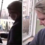 Ukrainian woman tearfully sings the national anthem while cleaning the glass of her bombed home