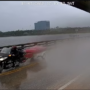 Watch: Terrifying moment motorcyclist hauling a trailer dangles off the gap of a Florida drawbridge