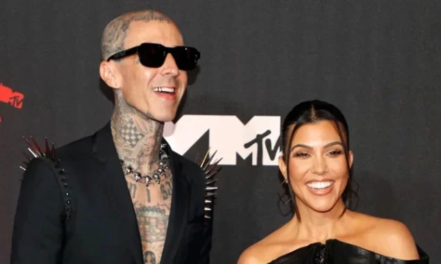 Kourtney Kardashian and Travis Barker play in the sand during a hot make-out session
