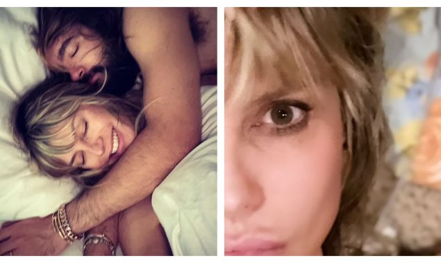 While lying in bed, Heidi Klum is serenaded by her shirtless husband Tom Kaulitz